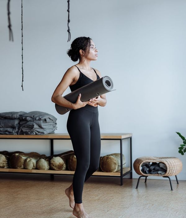 Woman holding a serene yoga pose in a calm studio.